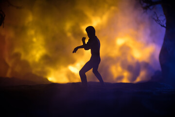 Karate athletes fighting scene on boxing ring with red ropes. Character karate. Posing figure artwork decoration. Sport concept. Decorated foggy background with light. Selective focus