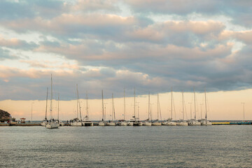 sailing yachts in the parking lot at the pier at sunset