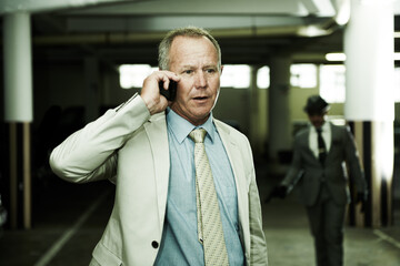 Completely unaware his life is about to change. An oblivious businessman talking on his cellphone...