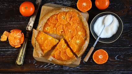 selective focus. Tangerine galette. Tart with tangerines. Preparation of citrus galette.