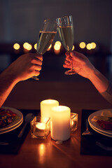 Heres to us and our future. Cropped shot of an unrecognizable couple having a celebratory toast...