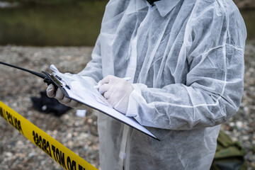 Close up on hands of unknown man crime scene detective inspector during investigation collecting...