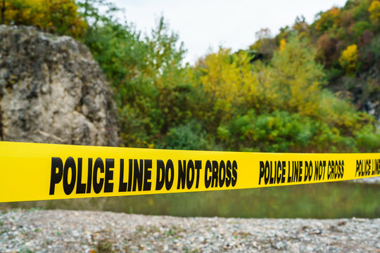 Police Line Do Not Cross On The Yellow Tape Securing Crime Scene In Nature Near The River On The Beach No People Copy Space