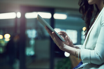 Technology enables access anytime, anywhere. Closeup shot of a businesswoman working late on a...