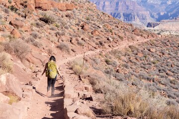 Female Hiker in Athletic Clothing and Hiking Backpack Descending South Kaibab Hiking Trail, Grand Canyon National Park Arizona USA