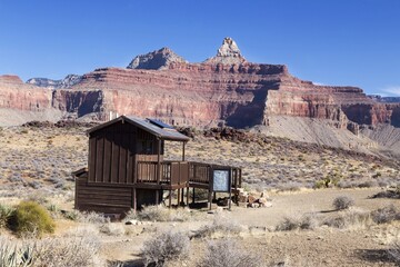 Rustic Outdoor Wooden Outhouse Shelter on South Kaibab Hiking Trail. Scenic Grand Canyon Arizona National Park Red Rock Formations Landscape. 