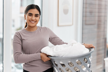 Laundry is actually infinite. Shot of a beautiful young woman doing the laundry at home.