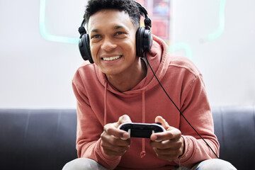 Dont hate the player. Cropped shot of a handsome young man playing video games at home.