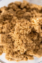 Light brown sugar in a glass container.