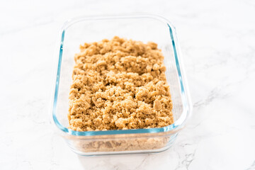 Light brown sugar in a glass container.