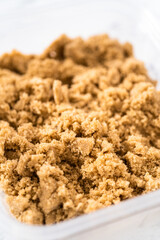 Light brown sugar in a glass container.