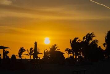 Sunset on paradise island with trees and clouds in the sky with lighthouse.