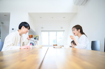 A couple eating dinner in the living/dining room