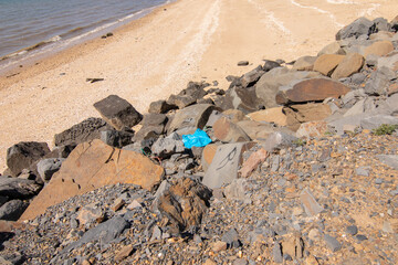 Fototapeta na wymiar Isla Cristina, Huelva, Spain. Garbage, plastic on the beach breakwater.