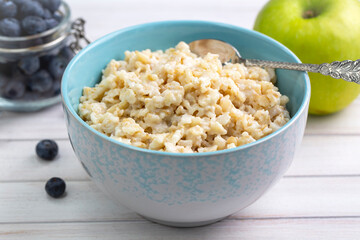 Healthy breakfast oatmeal porridge in bowl. Hot mashed oats, vegan vegetarian weight loss diet breakfast food