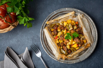 Traditional Turkish food; Meat with vegetables wrapped in greaseproof paper, kebab (Turkish name; Sebzeli kagit kebabi)