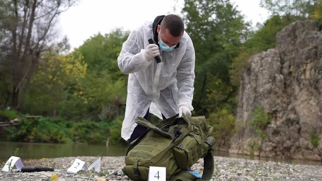 caucasian man forensic police on the crime scene 