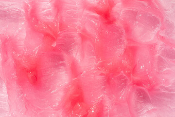 Fototapeta premium Moisturising and cleaning beauty product sample swatch. Cosmetic smear texture background. Pink creamy balm product closeup.