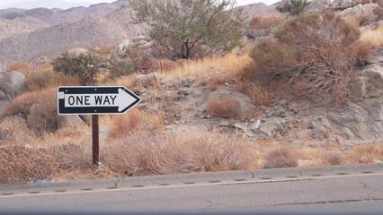 One way road transport sign with arrow on roadside or wayside, highway or freeway in California...