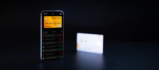 Mobile banking network. Smartphone with internet online bank application. Debit card on black background. Save money business concept.