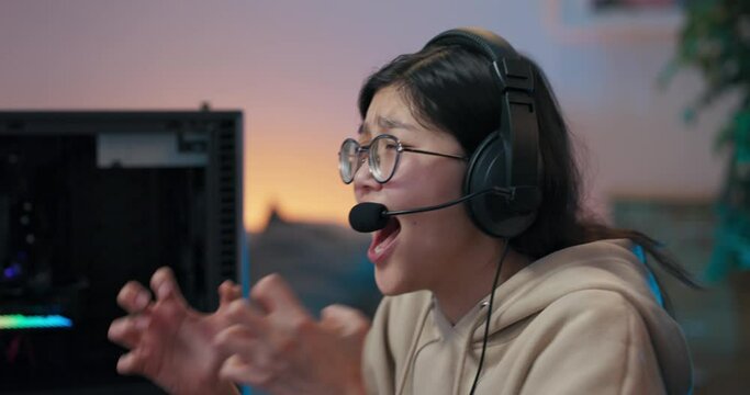 Professional gamer loses big money in online computer game, woman in headset shouts to team members, cries, breaks down, disqualification from online competition, waving hands in anger