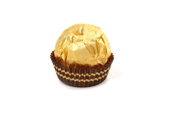 Round candy in a gold package and a paper capsule for a mini cupcake.