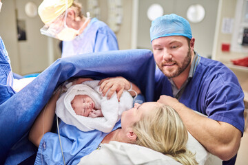 Shes perfect in every tiny way. Shot of a beautiful young couple welcoming their newly born baby girl in the hospital.