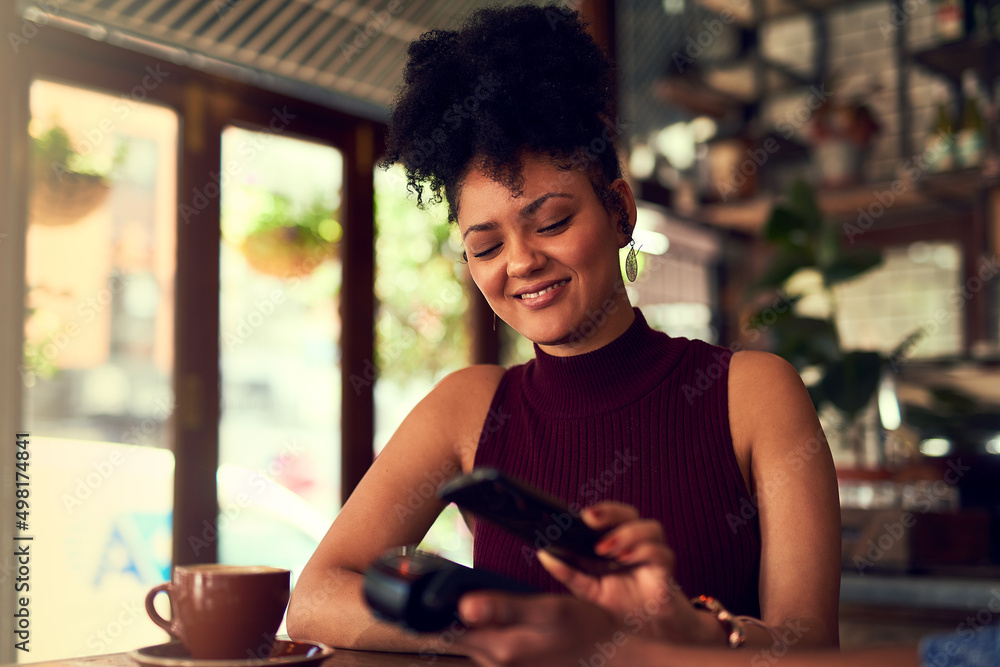 Aufkleber loving how easy it is to pay. cropped shot of a young woman paying using nfc technology in a cafe.