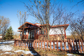 In winter, the wooden villa is under the blue sky