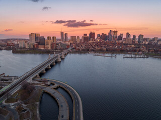 Sunset over Boston downtown with sky scrapers with views of the Longfellow bridge over the Charles...