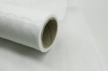 Universal white fabric napkins for cleaning in a roll. Bobbin with napkins for dispenser. Selective focus