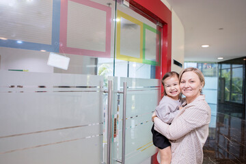 Fototapeta na wymiar Mother accompany daughter to entrances school