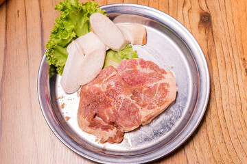 Raw pork on plate, Korean traditional style fresh pork beef belly BBQ, Japanese meat hot pot or Shabu in the restaurant, barbecue food