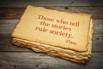 Those who tell the stories rule society, Plato, ancient Greek philosopher, quote. Inspirational handwriting on handmade paper with rough edges against rustic weathered wood, storytelling and narration