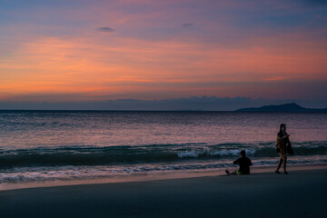Fototapeta premium Enjoying summer at the beach of Puerto Galera, Philippines at sunset