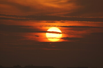 Clouds looks like intercepting the Sun while it is rising