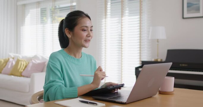Asia people young talent girl relax happy work at home office sit at table easy video call talk online teach or share in reskill upskill online class. Cozy workspace for distant workforce career job.