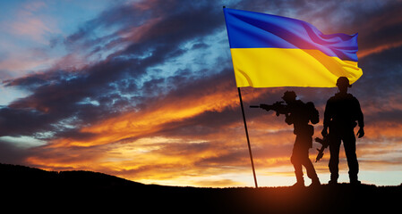 Flag of Ukraine with silhouette of soldier against the sunrise or sunset. Concept - armed forces of...