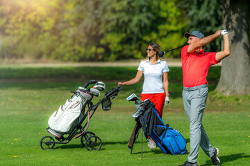 Young sportive couple on a golf course