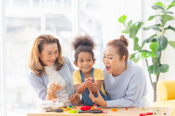 Little kid girl spending happy time with grandma, Child playing toys and game at home with positive senior grandparents in living room