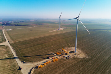 Installing new wind generator, Windmill turbine maintenance, Construction site with cranes for...