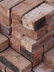 An isometric stack of various reclaimed house bricks