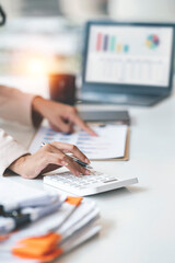 Businesswoman or accountant working Financial investment on calculator, calculate, analyze business and marketing growth on financial document data graph, Accounting, Economic, commercial concept.