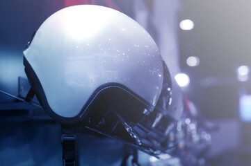 Helmet for motorcyclists hanging in a variety of colors.