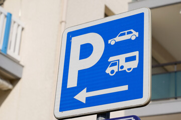 parking p arrow sign blue camper car motorhome parked in city street