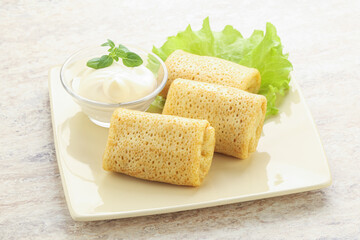 Stuffed pancakes with meat and cream