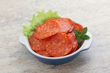 Sliced pepperoni sausage in the bowl