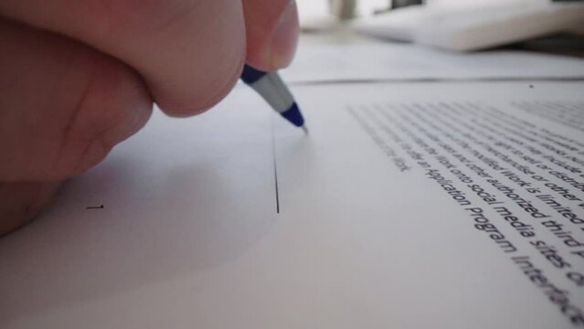 Close-up Moving Macro Shot: Signature on Contract by Pen in Male Hand. Sign Document on Deal at Office Work Indoors. Write Business Agreement or Undersign Protocol of Convention.