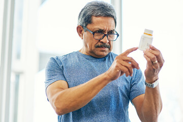This looks like itll work. Cropped shot of a handsome senior man reading a bottle of prescription medication.
