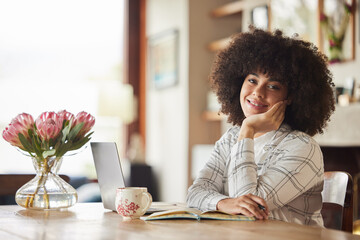 Strive for progress, not perfection. Shot of a you woman working in the lounge at home.